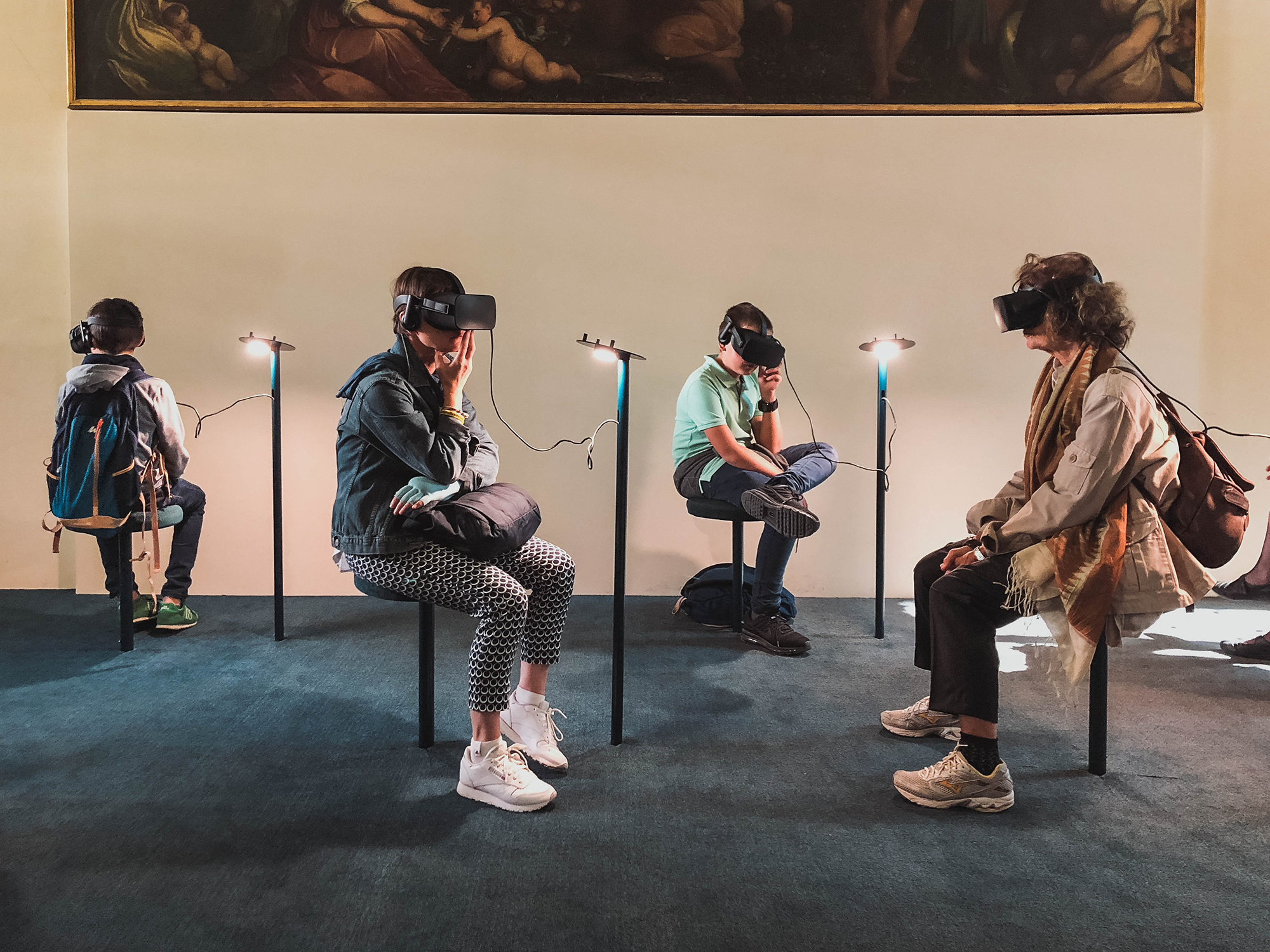 People sitting in a museum wearing virtual reality headsets